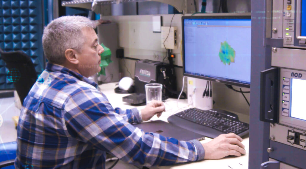 Person Looking at Computer Monitor with Data Graphic