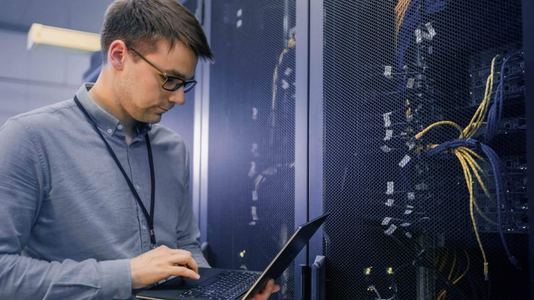 Person with Laptop Next to Cables