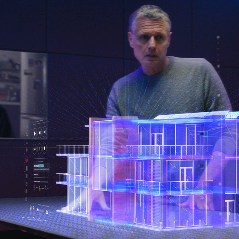 Man standing in front of a holographic building.