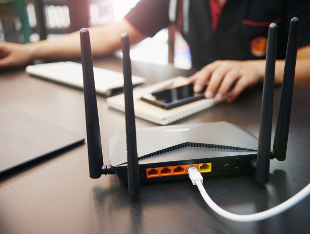 A DOCSIS certified modem standing on a desk