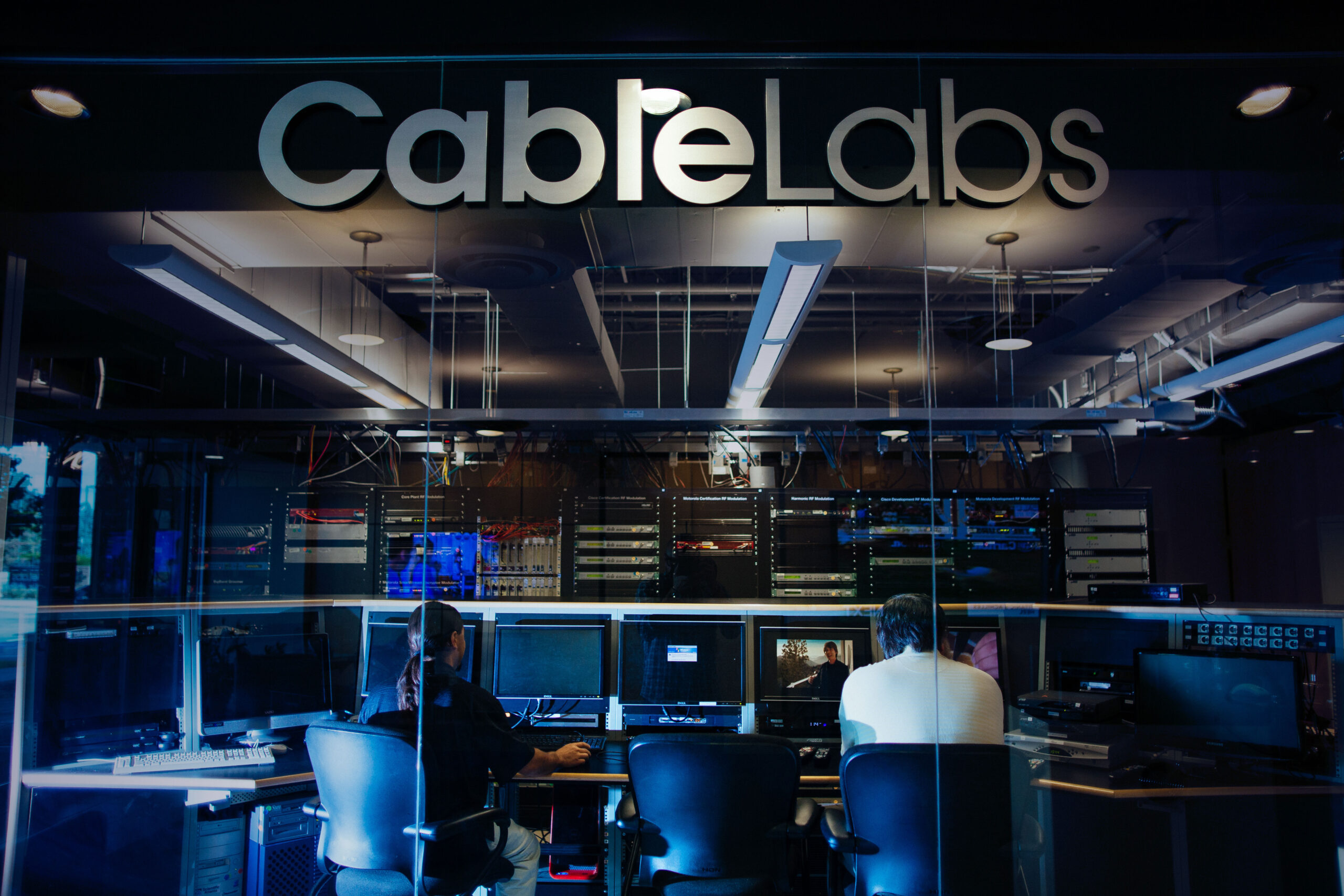 Photos of individuals in a lab at CableLabs